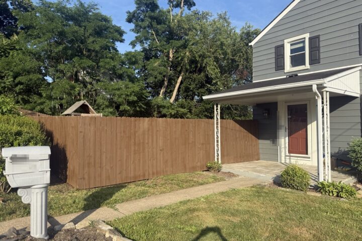 Completed stained wood privacy fence in Aliquippa, Pennsylvania